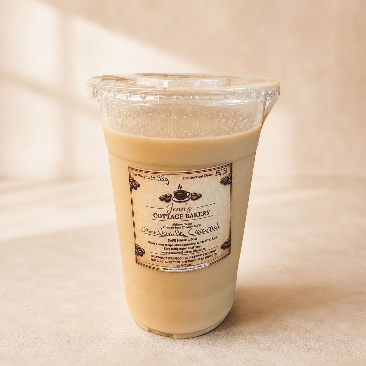 16 oz hand-poured iced craft coffee in a clear cup with Jenn’s Cottage Bakery label